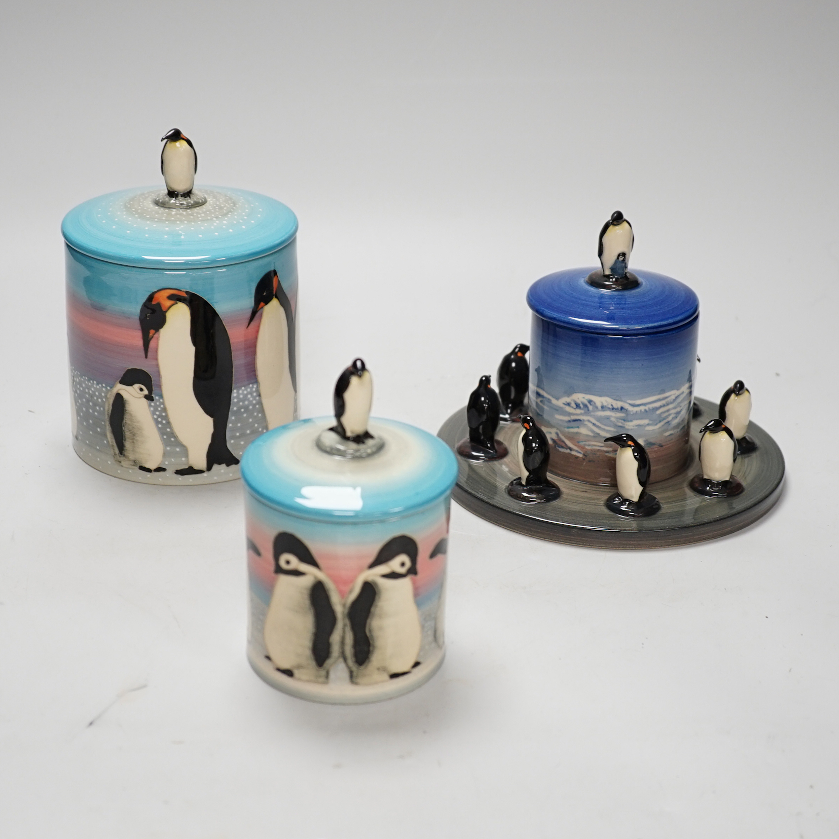 Three Sally Tuffin for Dennis China Works biscuit barrels with penguin knops, the largest 16cm high